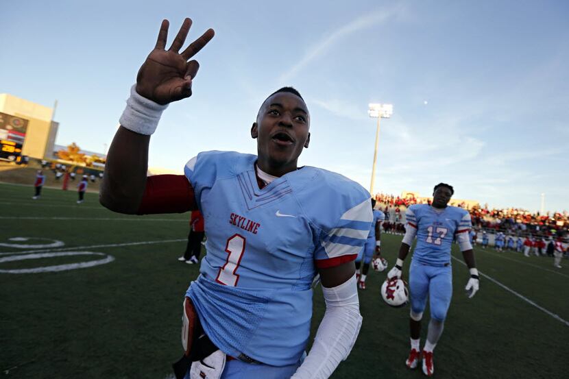 Skyline quarterback Devante Kincade signals to fans following the Raiders' 47-28 Class 5A...