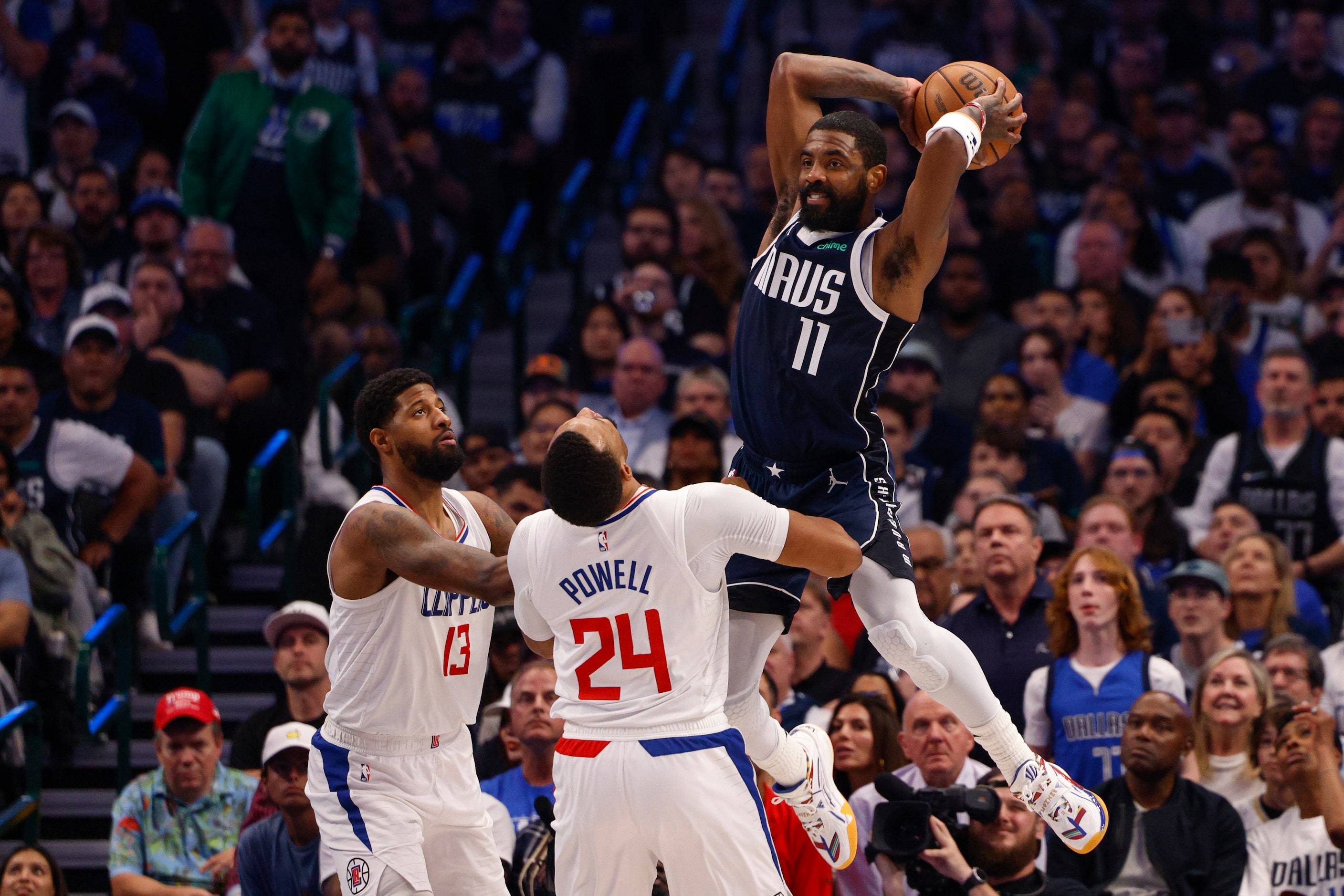 Dallas Mavericks guard Kyrie Irving (11) passes the ball over LA Clippers forward Paul...