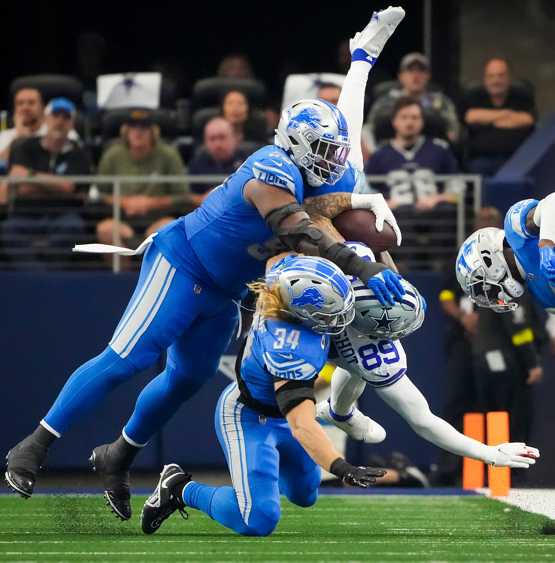 *Dallas Cowboys tight end Peyton Hendershot (89) is upended by Detroit Lions linebacker Alex...