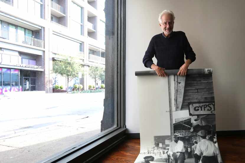 Alan Govenar unfurls a panel of artwork that will be on display in the new center. "People...