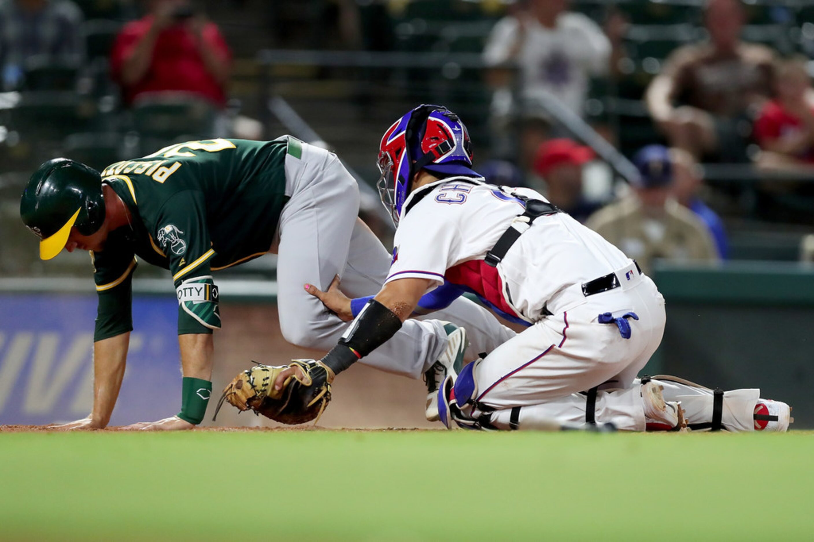 ARLINGTON, TX - JULY 23:  Robinson Chirinos #61 of the Texas Rangers tags out Stephen...