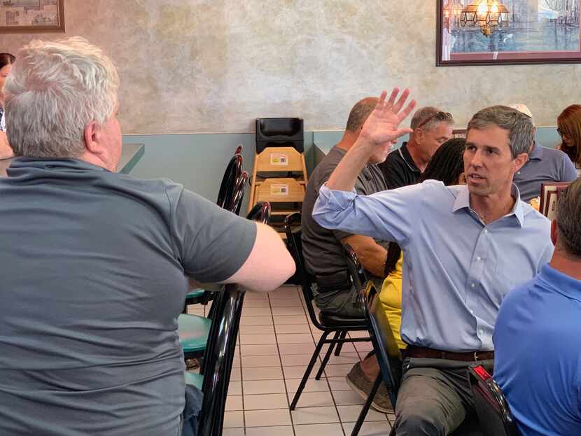 Democratic presidential candidate Beto O'Rourke talks to a potential voter at John's Family...