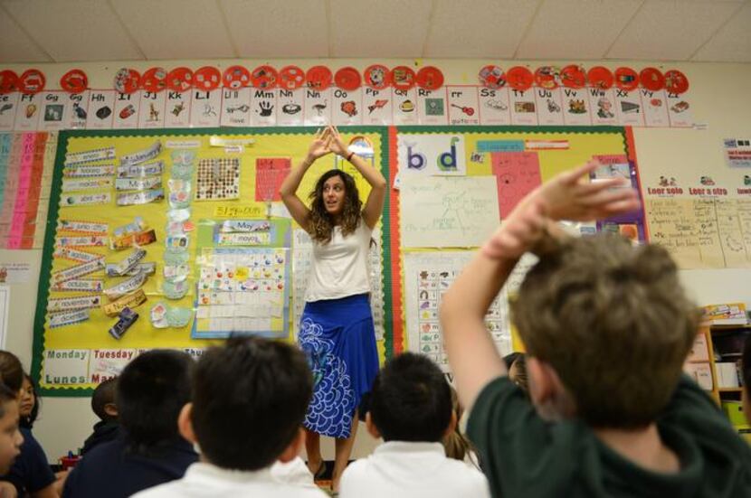 
Dual-language teacher Raquel Rodriguez sings in Spanish to kindergartners at Alex Sanger...