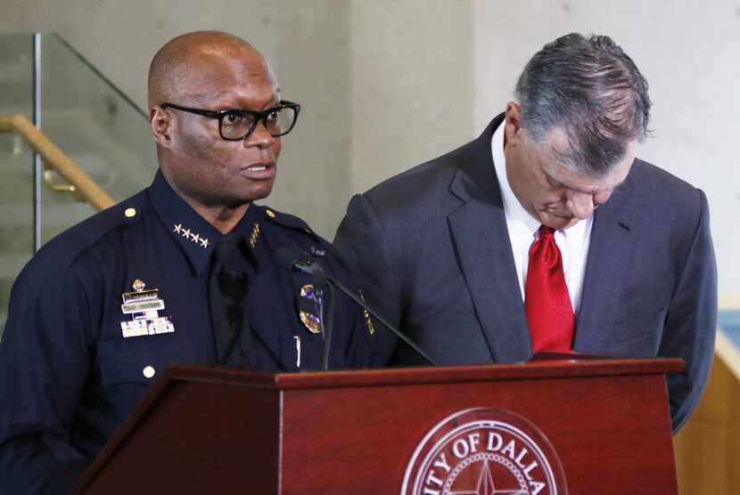 Dallas Police Chief David Brown, left, and Dallas Mayor Mike Rawlings, talks with the media...