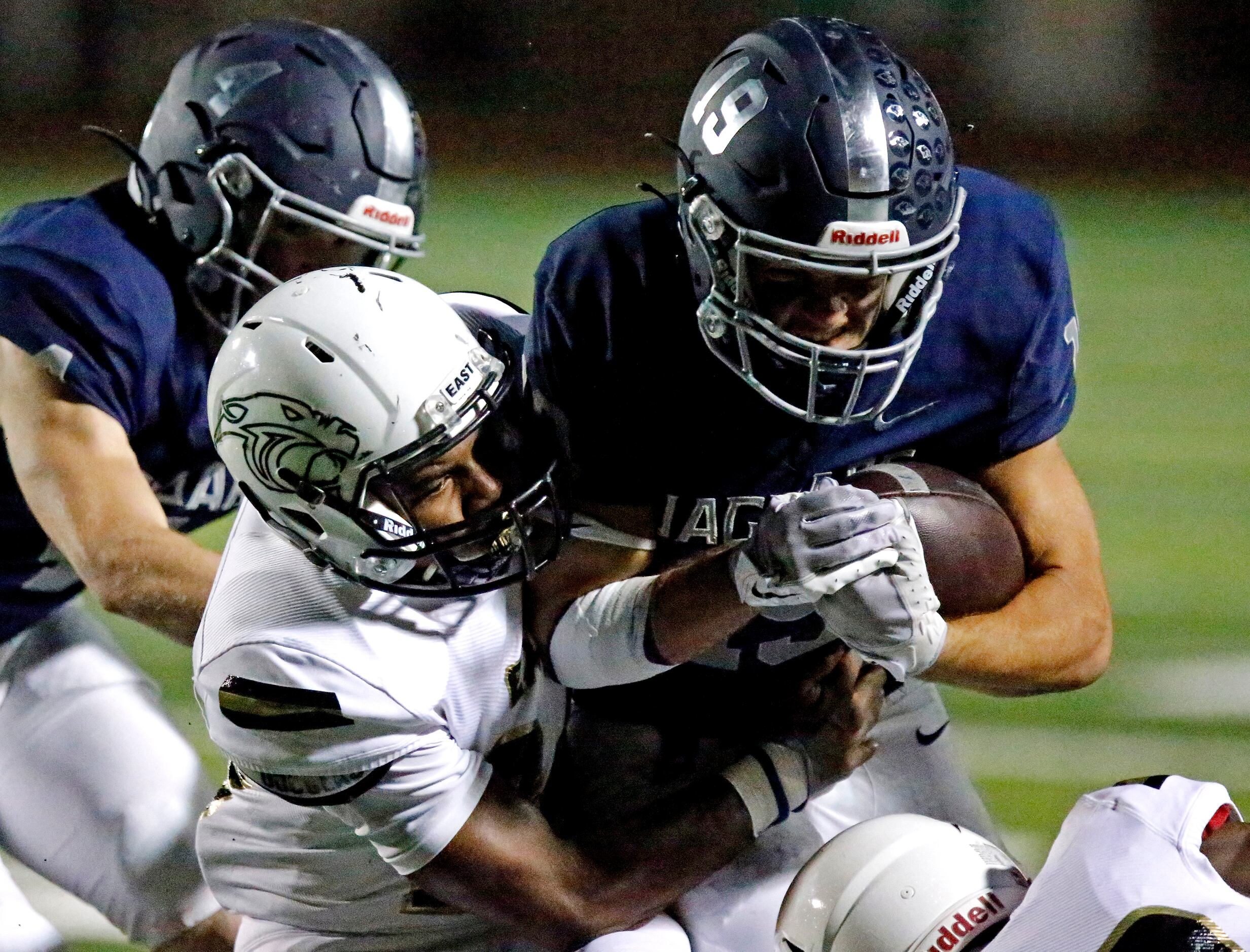 Plano East High School defensive back Ahmari Malone (24) tackles Flower Mound High School...