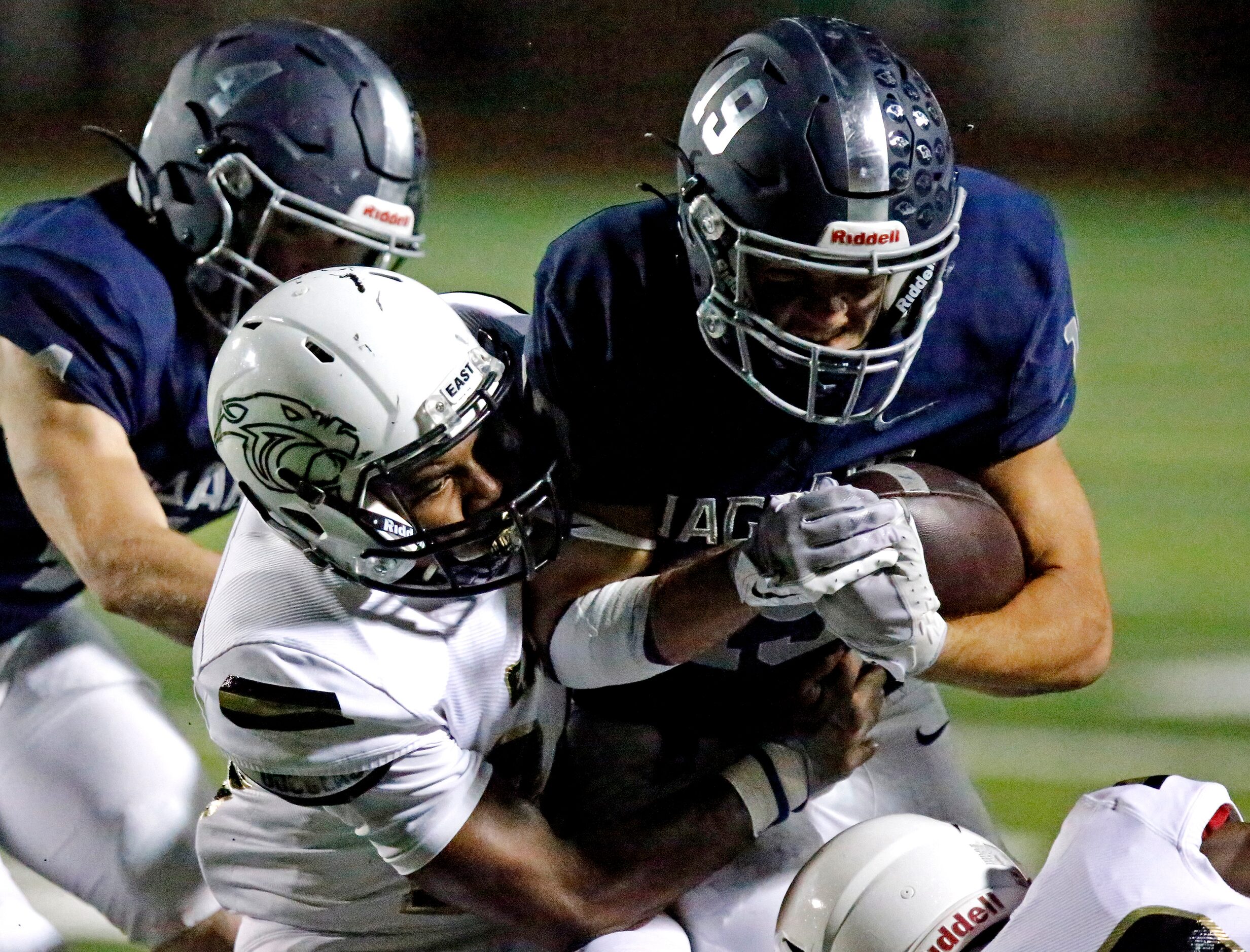 Plano East High School defensive back Ahmari Malone (24) tackles Flower Mound High School...