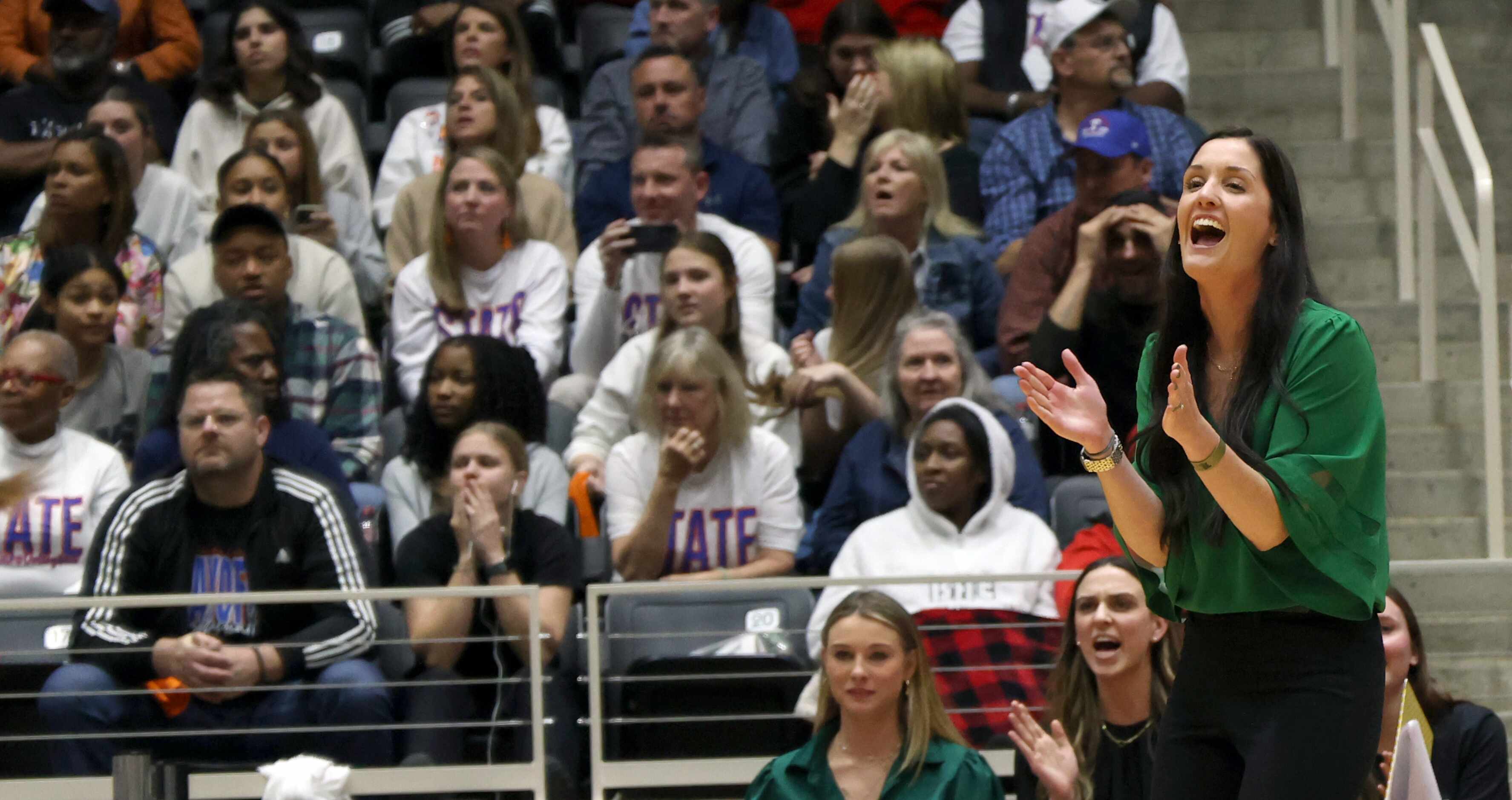 Prosper head coach Ashlee McCormick, right, reacts after a score during the first set of...