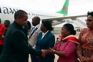 Malawi Vice President Saulos Chilima, left, greets government officials upon his return from...