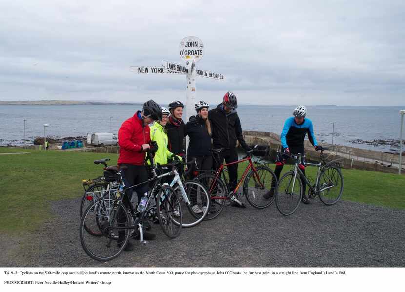 Cyclists on the  500-mile loop around Scotland’s remote north   pause for photographs at...