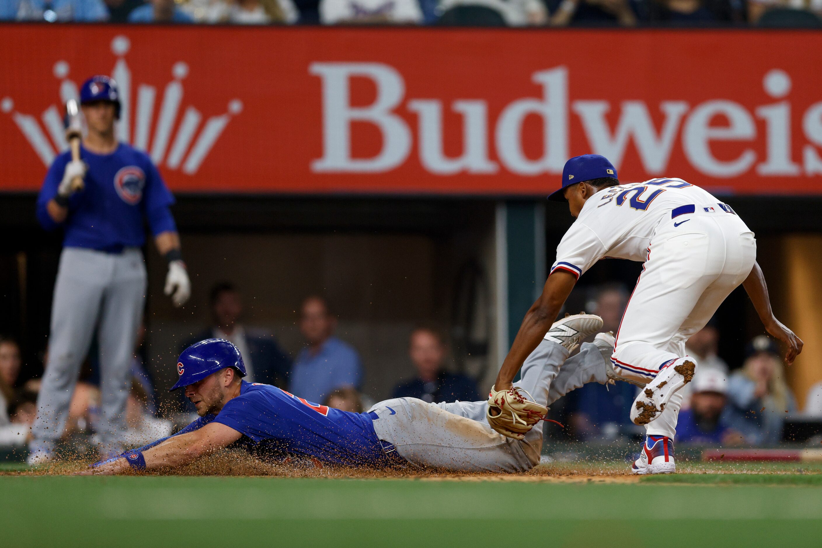 Texas Rangers relief pitcher Jose Leclerc (25) reaches to try and tag Chicago Cubs first...