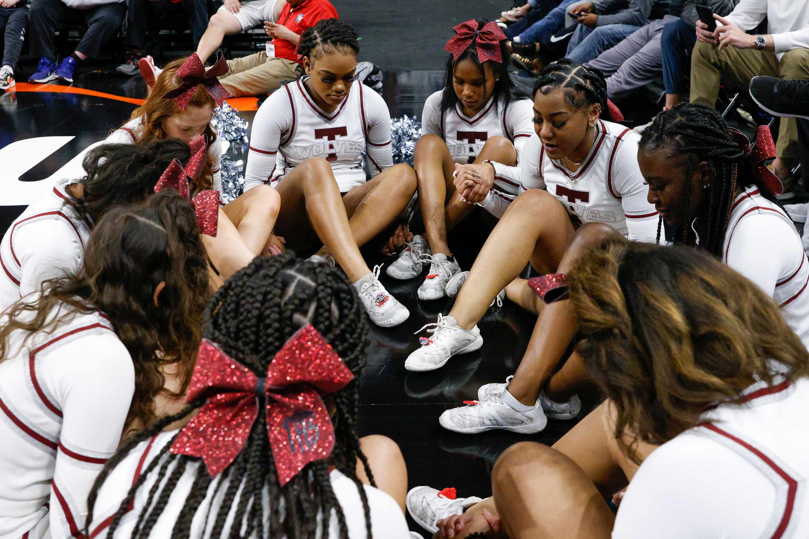 Mansfield Timberview cheerleaders say a prayer during the third quarter of the Class 5A...