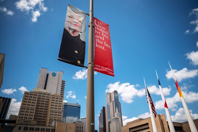 About 60 banners in downtown Dallas show 12 different designs featuring photos and quotes...