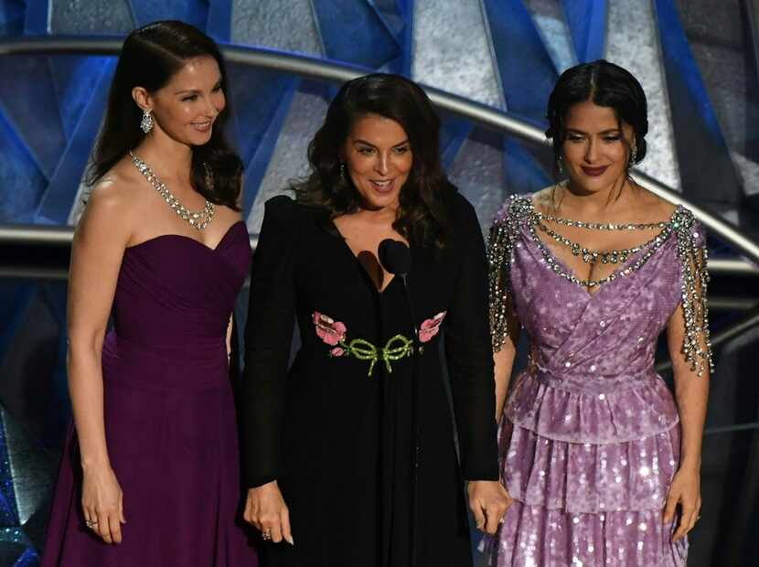 From left, Ashley Judd, Annabella Sciorra and Salma Hayek deliver a speech about sexual...