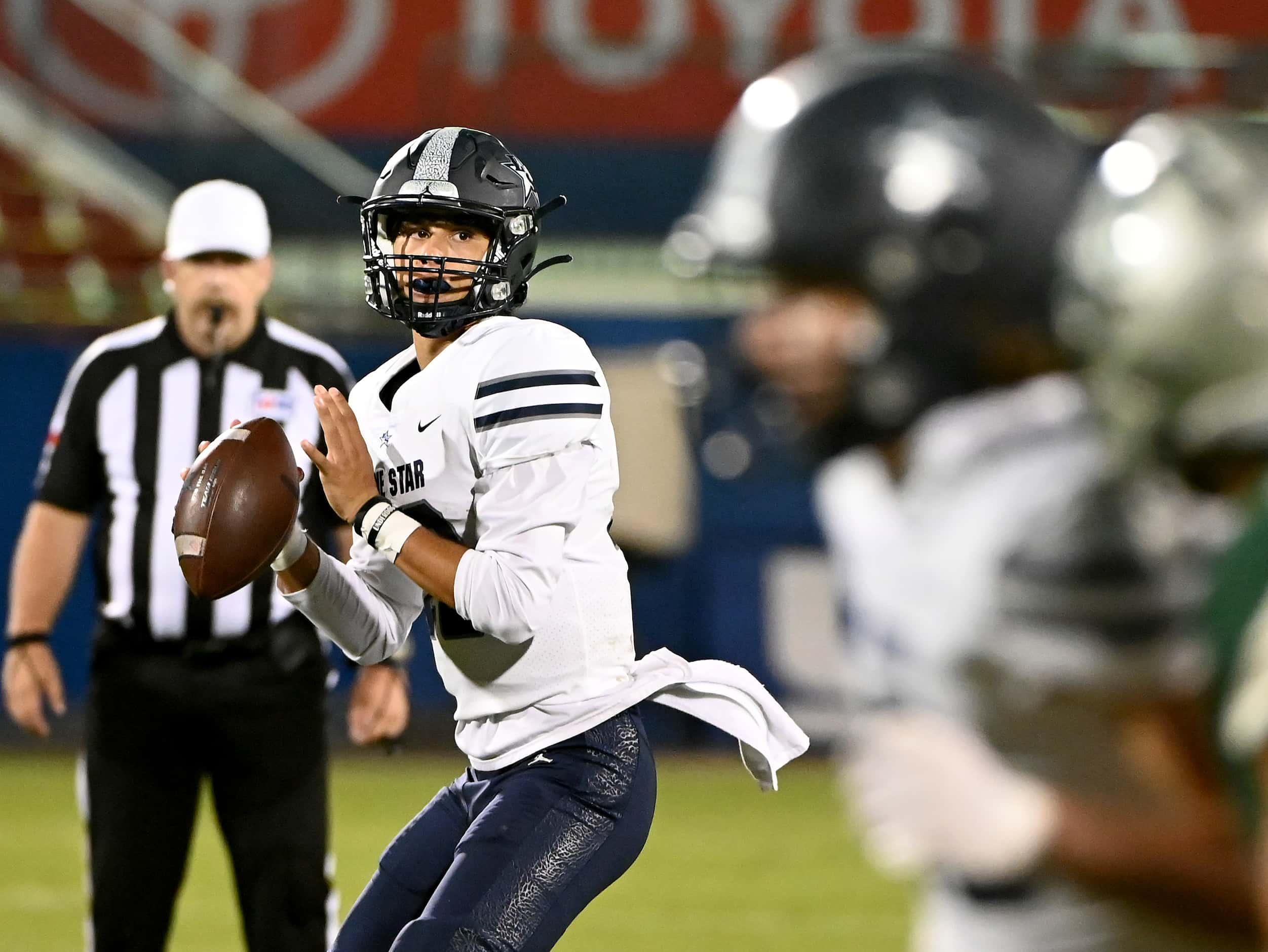 Frisco Lone Star’s Garret Rangel looks to pass in the first half of a high school football...