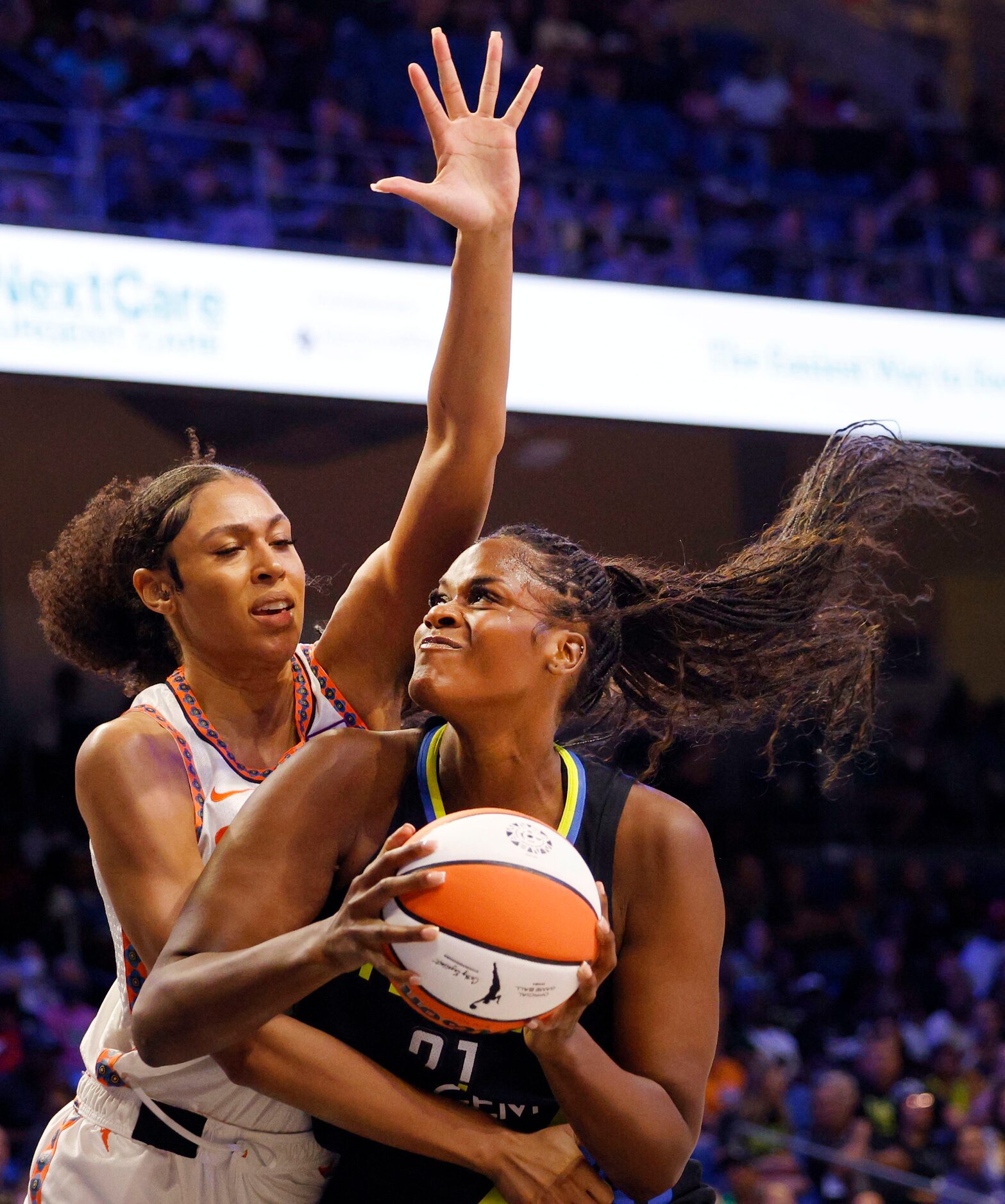 Dallas Wings center Kalani Brown (21) tries to shoot over Connecticut Sun forward Olivia...