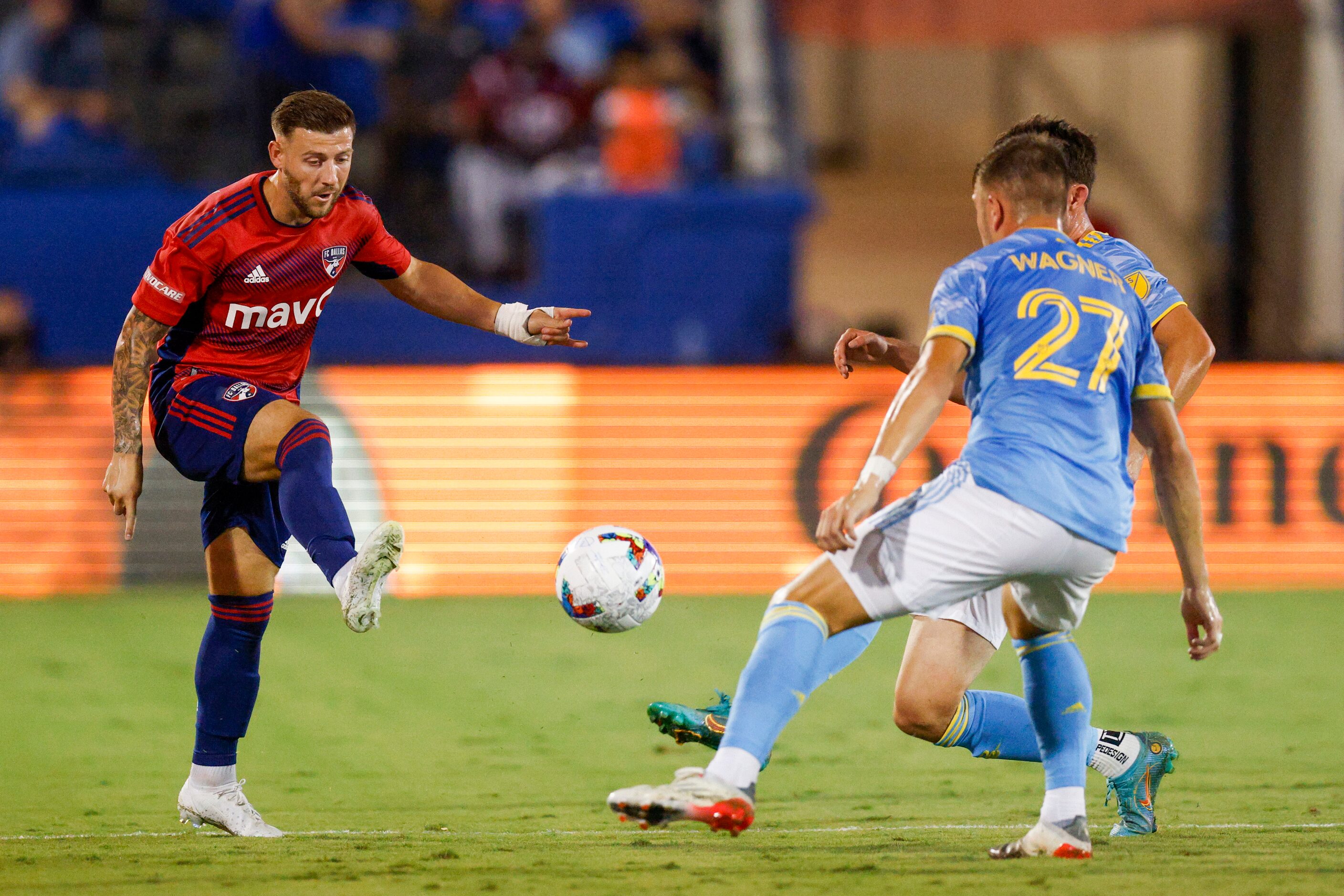 FC Dallas forward Paul Arriola (7) passes the ball around Philadelphia Union defender Kai...