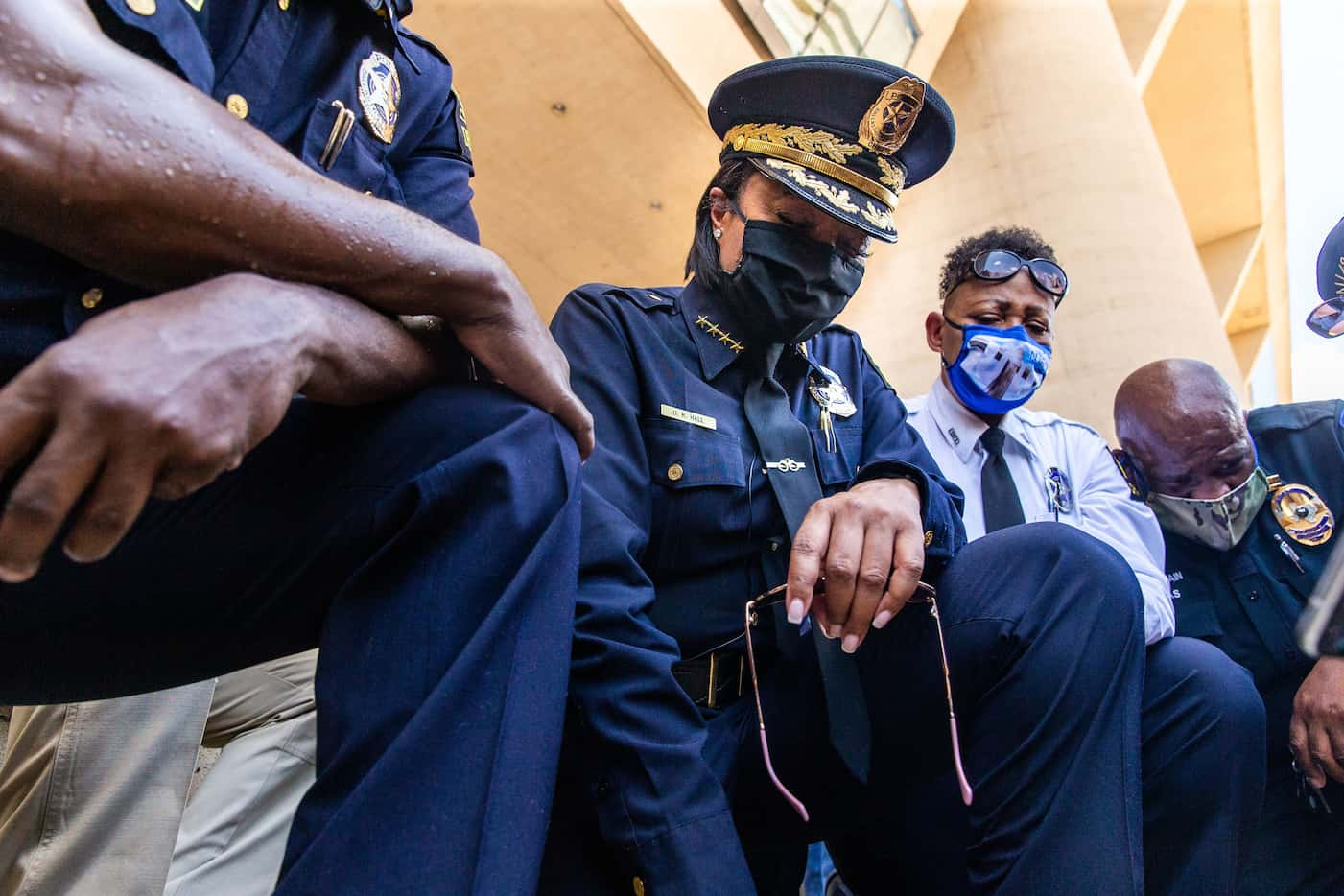 Chief U. Renee Hall (center) weeps as she and other officers kneel for 8 minutes and 46...