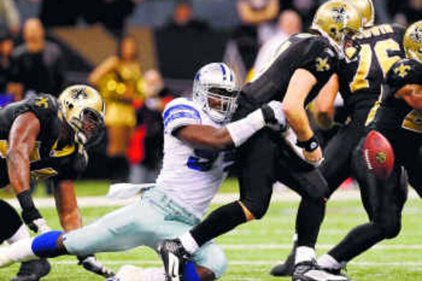  DeMarcus Ware sacks the Saints' Drew Brees and forces a fumble to secure the Cowboys'...