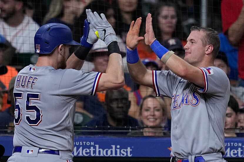 Texas Rangers' Sam Huff is congratulated by Josh Jung after hitting a solo home run during...