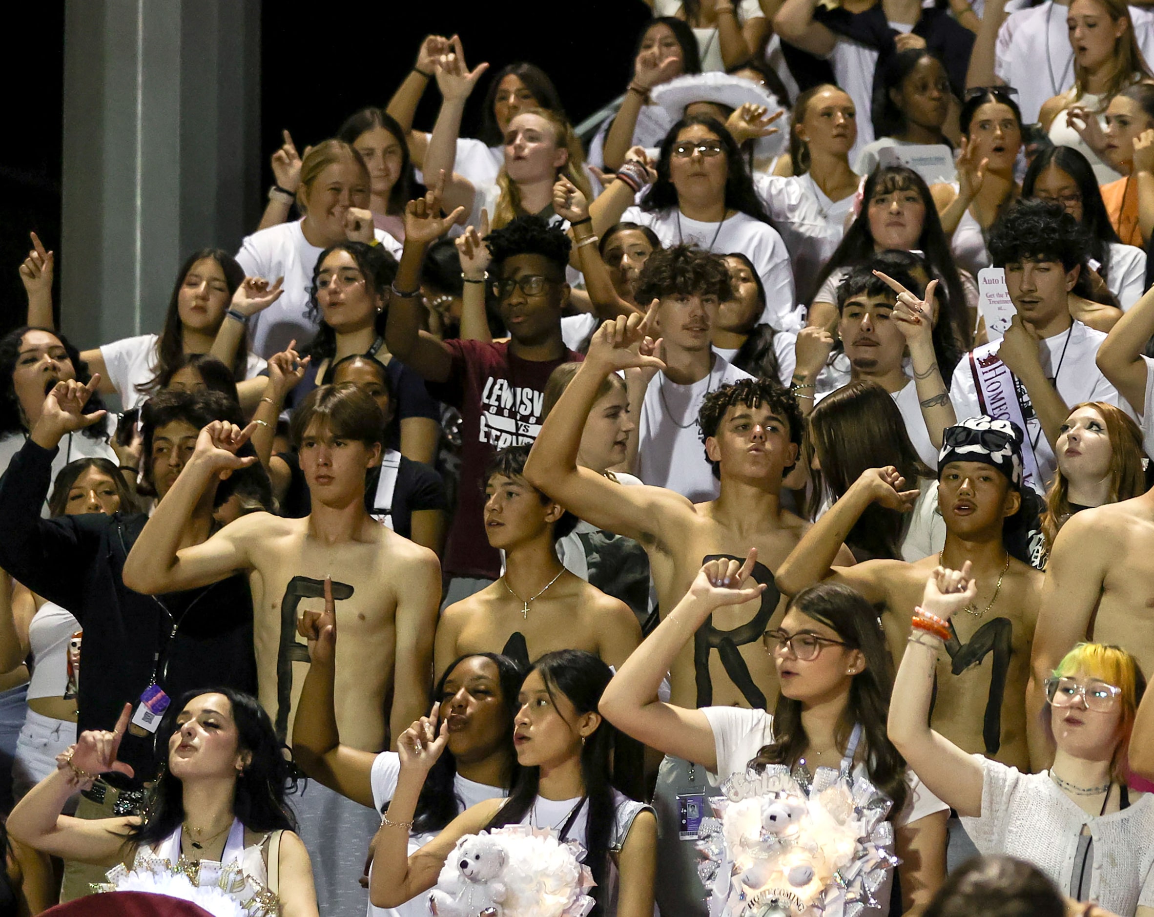 The Lewisville students cheer on their Fighting Farmers against Denton Braswell in a...