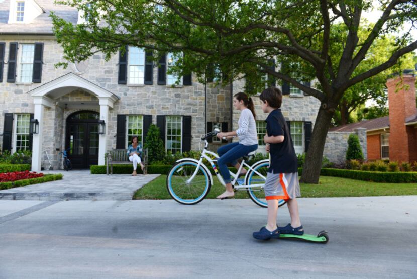 Grant Waco, 7, and his sister Avery, 13, play in the driveway of their University Park home,...