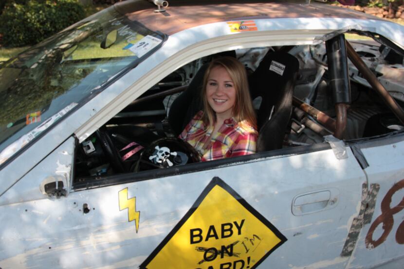 Olivia Leonard sits behind the wheel of "Baby on Board," a car the Leonard family races in...