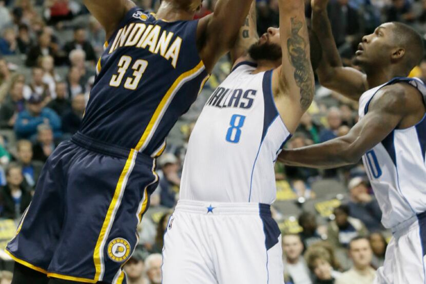 Indiana Pacers center Myles Turner (33) shoots against Dallas Mavericks defenders Deron...