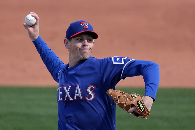 Texas Rangers pitcher Nick Tepesch throws during an exhibition spring training baseball game...