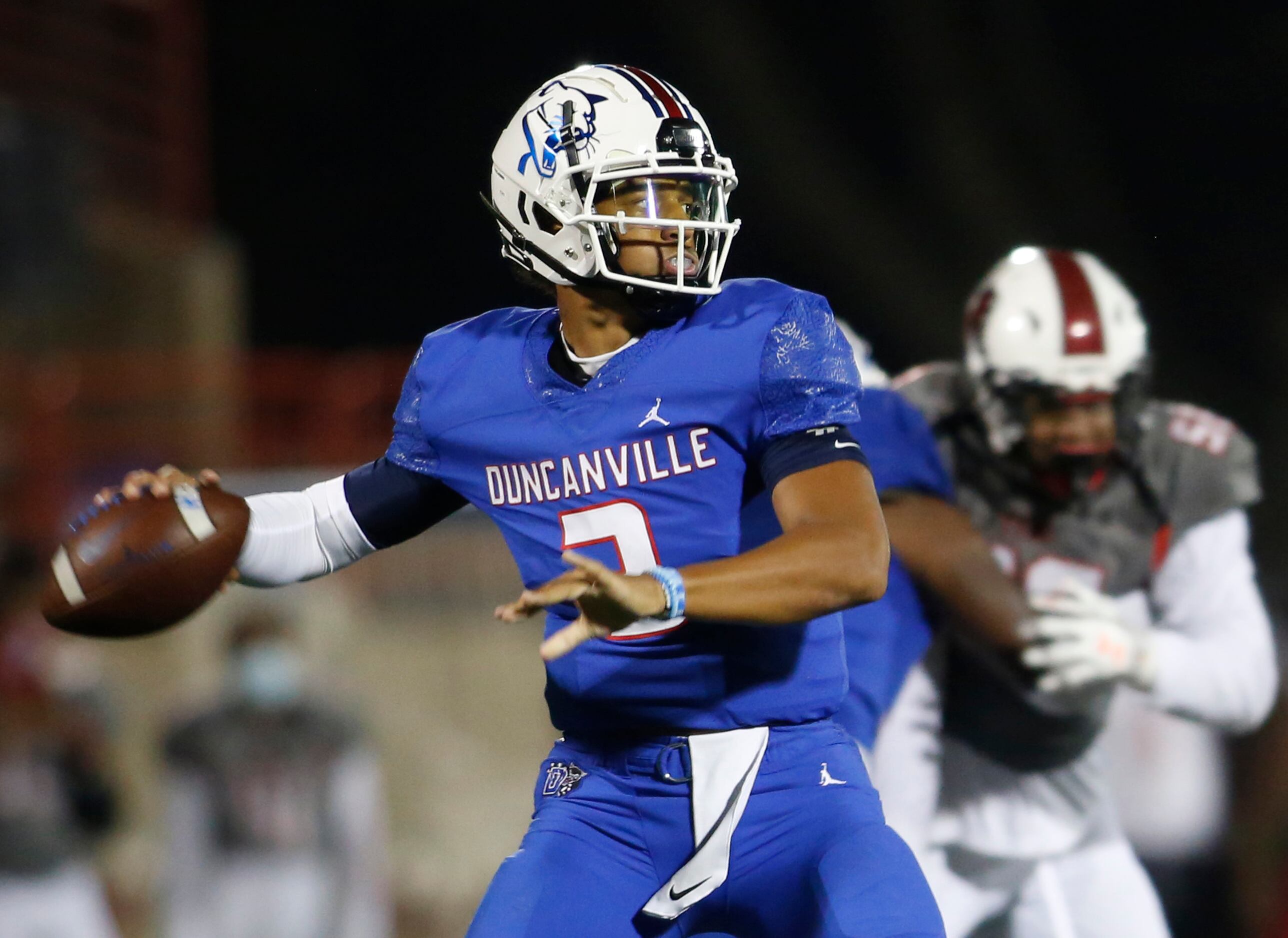 Duncanville quarterback Grayson James (3) looks to pass downfield during first quarter...