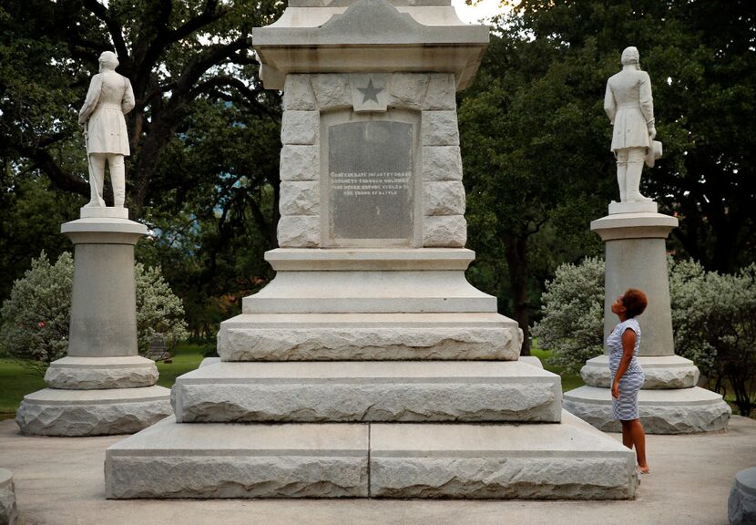 Victoria Miller of Dallas reads an inscription on the Confederate War Memorial in Pioneer...