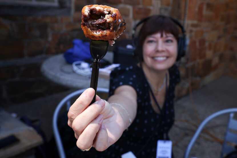 Julie Fisk holds Deep-fried Rocky Road on a fork on Friday, Sept. 30, 2022 at the State Fair...