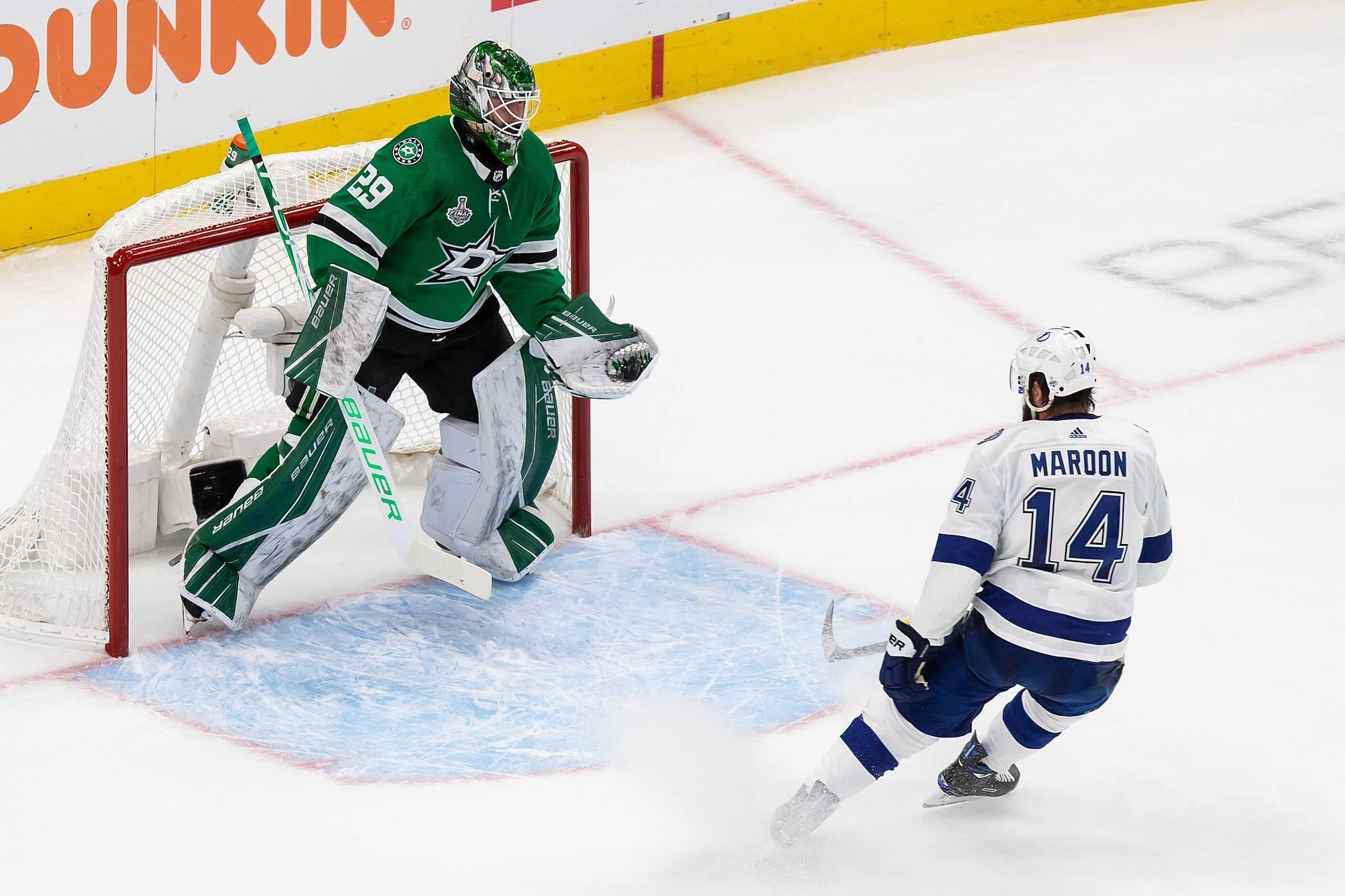 Goaltender Jake Oettinger (29) of the Dallas Stars makes a save against Pat Maroon (14) of...