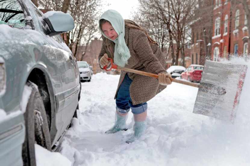 Gilda Mosely dug her car out from the snow outside her home Jan. 7. The winter of 2013-14...