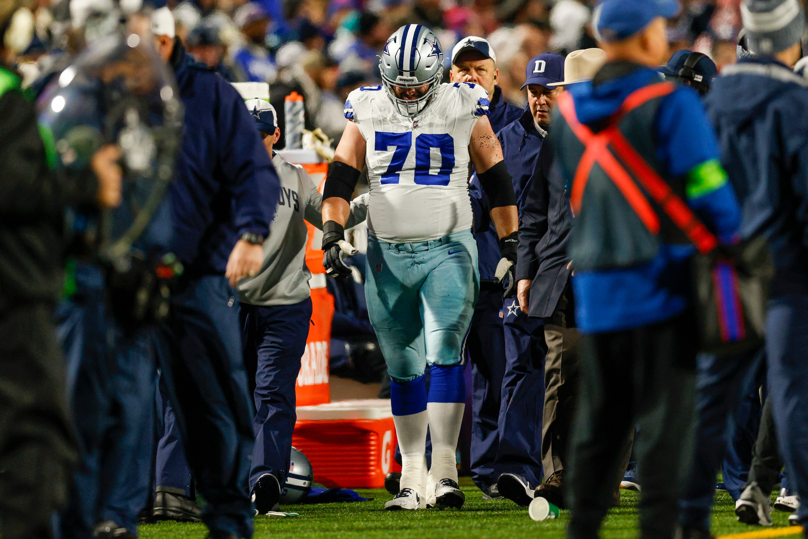 Dallas Cowboys guard Zack Martin (70) walks to the medical tent after suffering a leg injury...