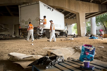 A crew from Green Planet Recycling prepared to clean up a homeless encampment Tuesday near...