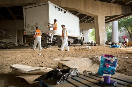 A crew from Green Planet Recycling prepared to clean up a homeless encampment Tuesday near...