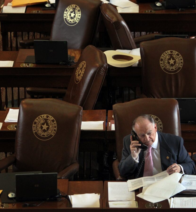 State representative Dan Flynn, R-Canton, works the phones during a break in the Sunday...