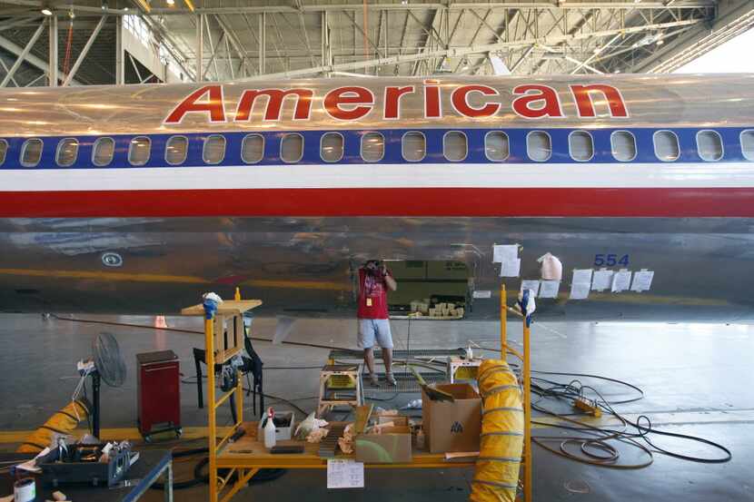 American Airlines Aviation Maintenance Technician Leslie Kennedy works on replacing a part...