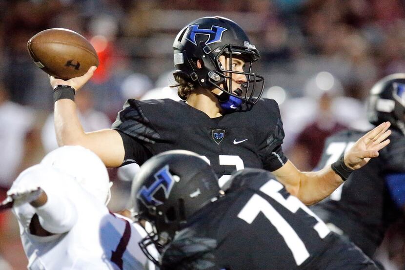 Hebron High School quarterback Clayton Tune (12) throws a pass during the first quarter as...