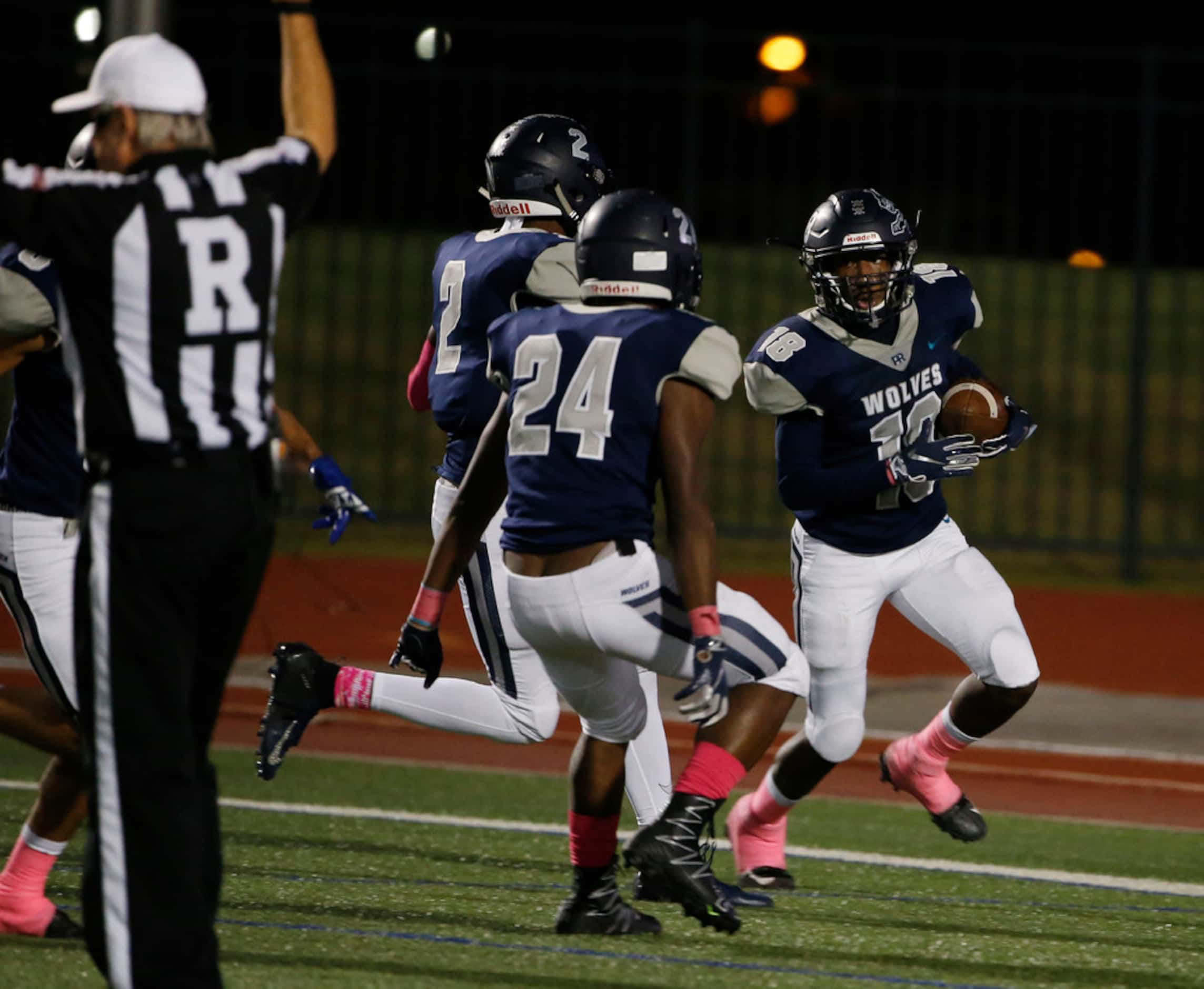 Ranchview's Larry Bargeman (18) is congratulated by Chauncey Penny (2) and Joshua Walker...