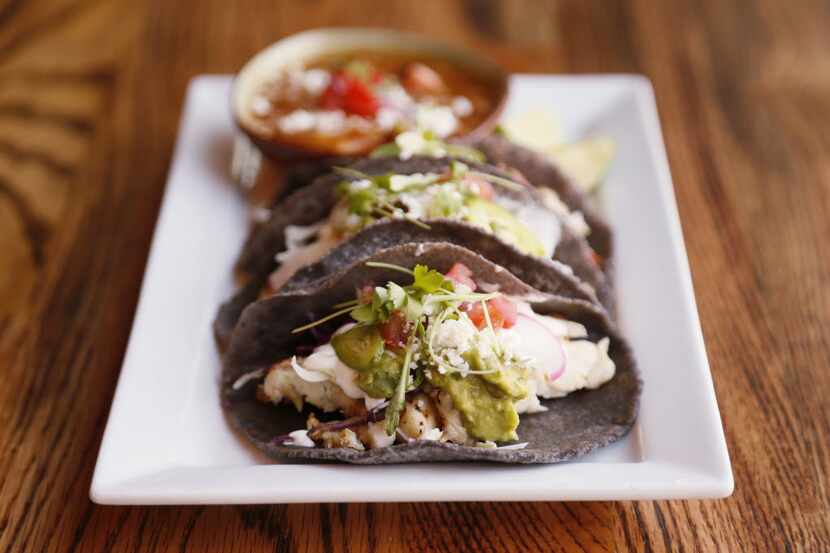 Here's a look at El Bolero's tacos de pescado (fried) con frijoles charros.