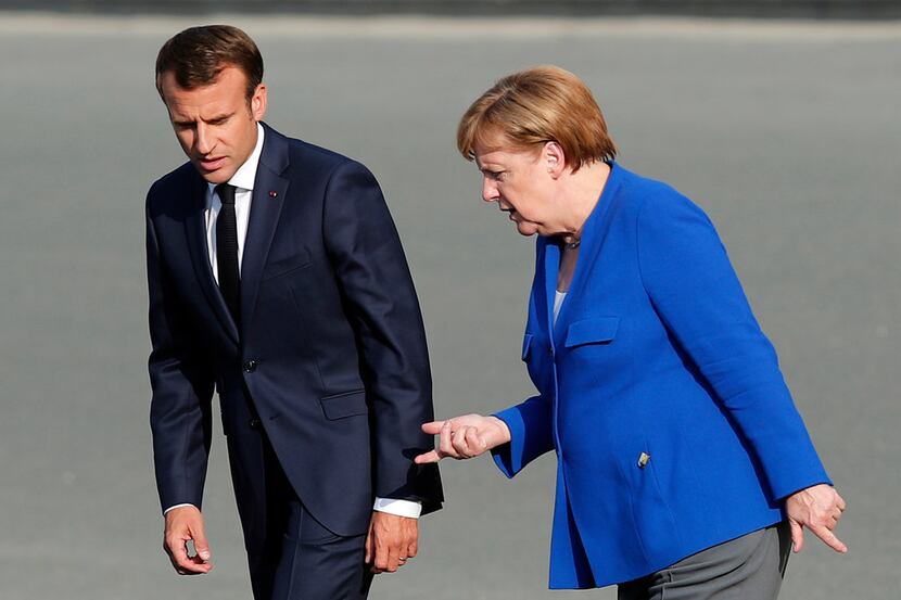 French President Emmanuel Macron (left) and German Chancellor Angela Merkel arrive for a...