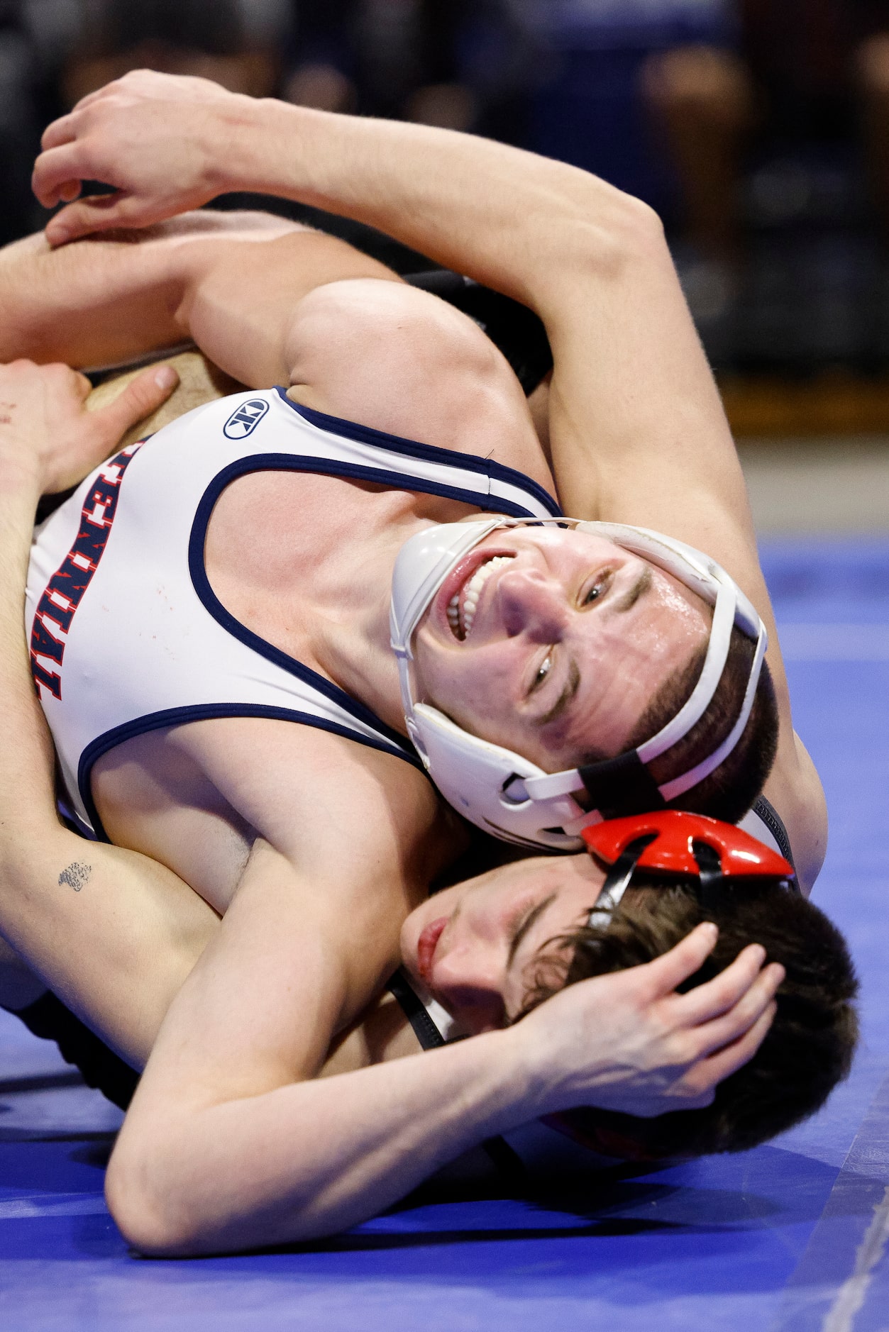 Jasin Sejdini of Frisco Centennial (top) wrestles Joshua Thomas of Conroe Caney Creek during...