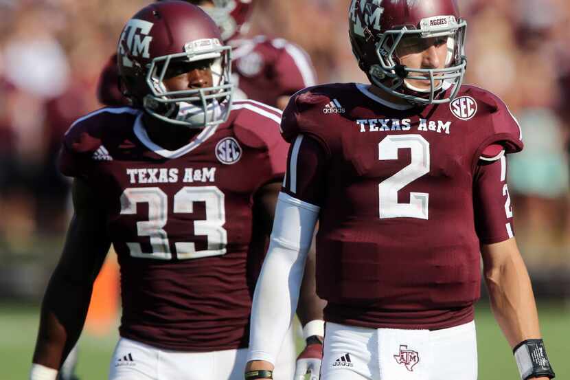 Texas A&M running back Christine Michael (33) and quarterback Johnny Manziel (2) look to the...