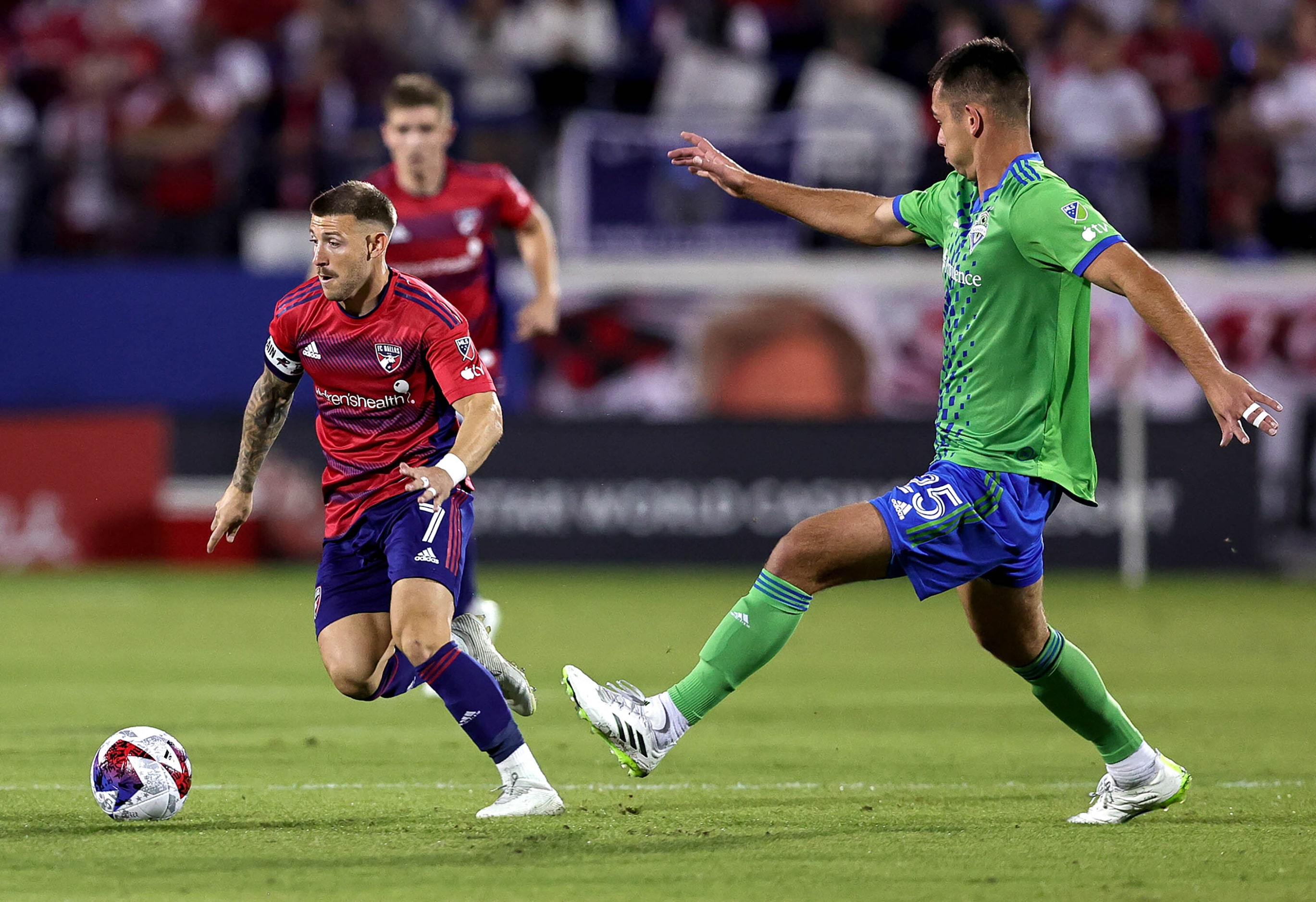 FC Dallas attacker Paul Arriola (7) tries to dribble past Seattle defender Jackson Ragen...