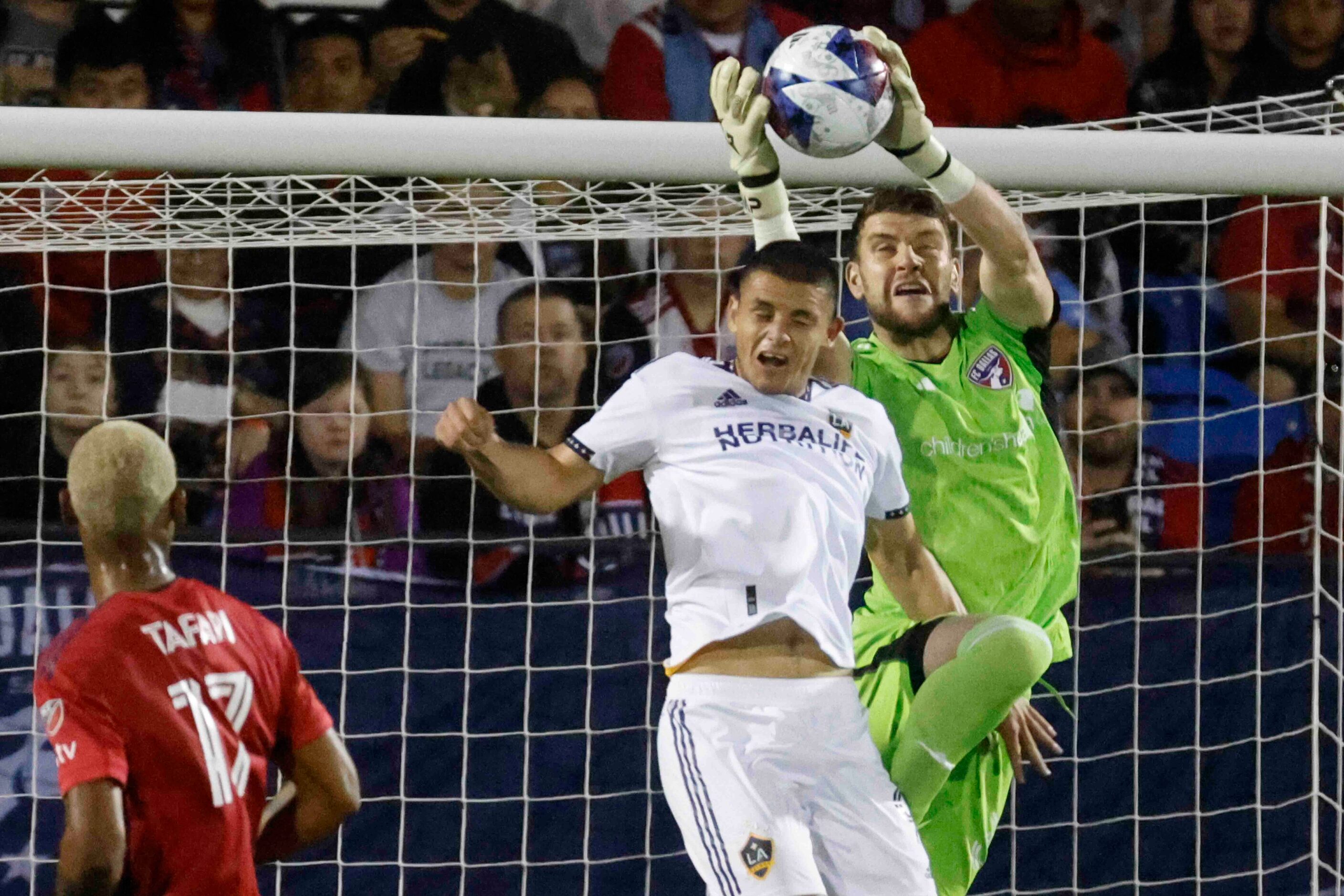 Los Angeles Galaxy forward Dejan Joveljić (left) tries to head from a cross as FC Dallas...