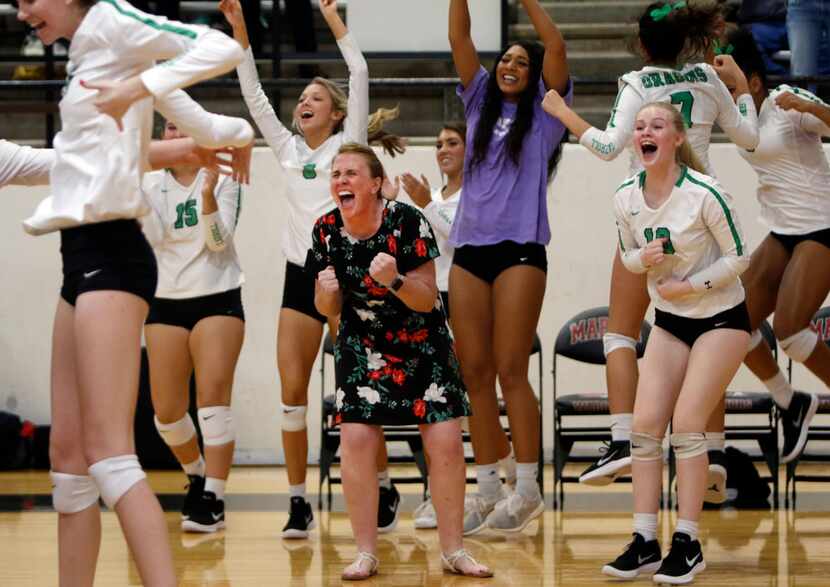 Southlake Carroll coach Teresa Dunn leads an ecstatic celebration following the final point...