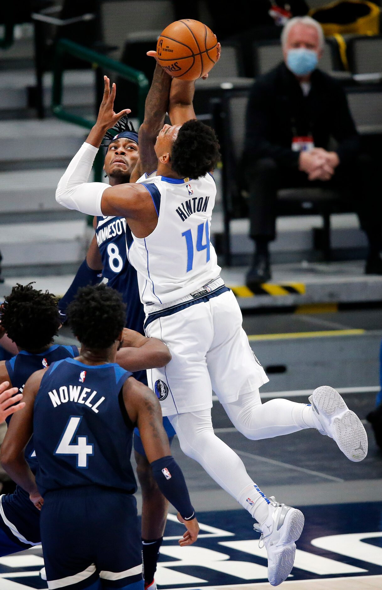 Dallas Mavericks guard Nate Hinton (14) is found by a Minnesota Timberwolves player in...