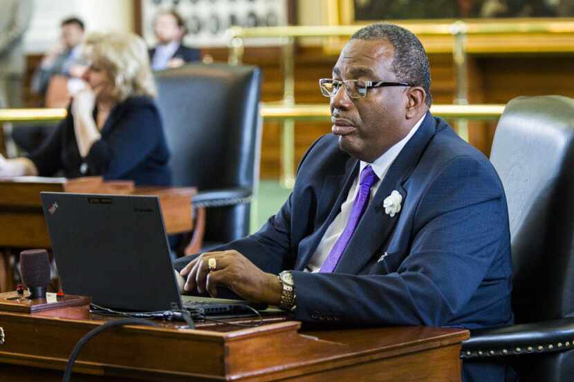 Sen. Royce West, D-Dallas, works at his desk during the final day of the 84th Texas...