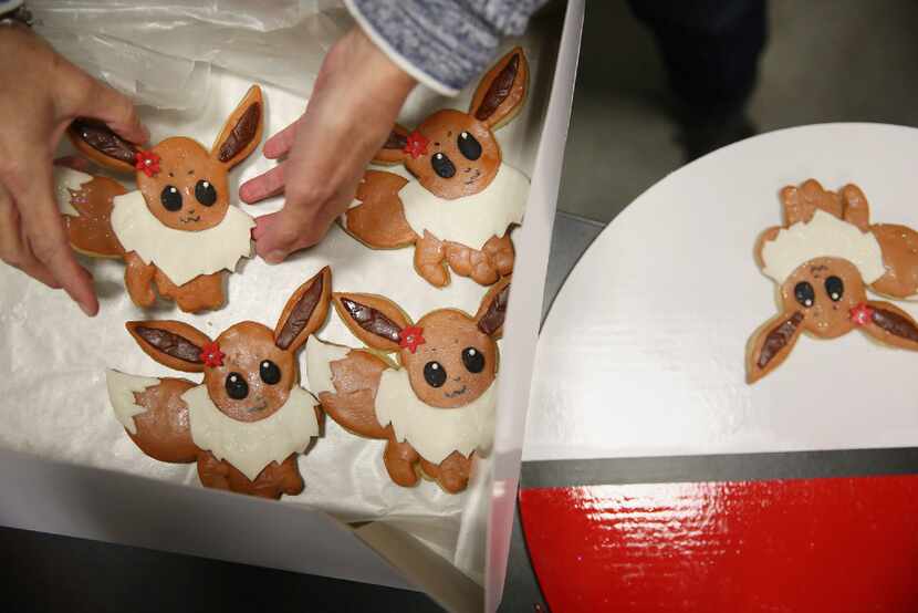Jana Gibson of Arlington drops off her Pokemon-themed cookies during the 21st annual Holiday...